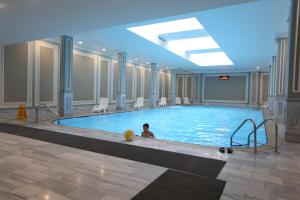 a person in a swimming pool in a building at Astrakhanskaya Hotel in Astrakhan