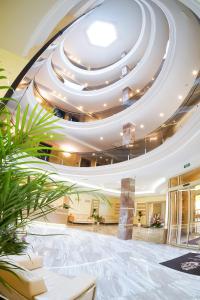 a large lobby with a large ceiling at GRAND OTRADA Hotel Resort & SPA in Odesa