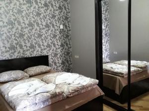 a bedroom with two beds and a mirror at GTNL Aparthotel in Tbilisi City