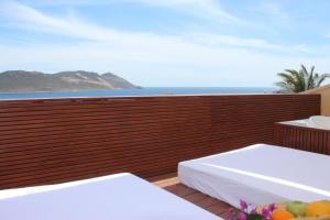 a balcony with two beds and a view of the ocean at Lycia Hotel in Kaş