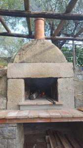 a large stone oven with a stove in it at La Corte del Falco in Pieve a Nievole