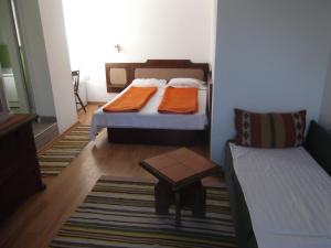 a room with two beds and a table and a couch at Guest House Fanari in Sozopol