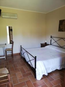 een slaapkamer met een bed, een tafel en een stoel bij Agriturismo Prati degli Orti in Montiano