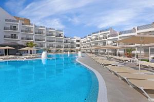 a swimming pool in front of a hotel at Palmanova Suites by TRH in Magaluf