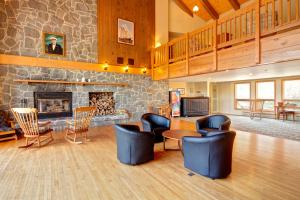 a living room with chairs and a fireplace at Liscombe Lodge Resort & Conference Center in Liscomb