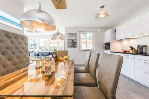 a kitchen and dining room with a table and chairs at Haus Charlotte in Zingst