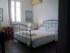 a bedroom with a bed and a window at Blue Dolphin in Batsi
