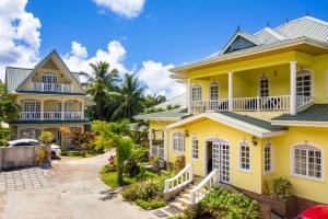 an image of a yellow house at Captain's Villa in Takamaka