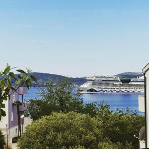 a cruise ship is docked in the water at Apartment Karma in Zadar