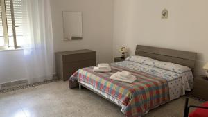 a bedroom with a bed with two towels on it at Casello sul Mare in San Nicola Arcella