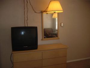 a television sitting on top of a dresser with a mirror at Fels Three Crown Motel in Clarence