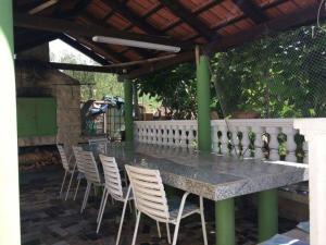 a table and chairs sitting under a pergola at Apartments Kolak in Rogoznica