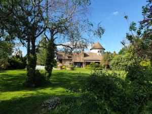 a house in the middle of a green yard with trees at Le Fuchier in Saint-Martin-de-Fressengeas +30 photos