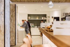 two men standing at a counter in a kitchen at C-Hotels Helios in Blankenberge