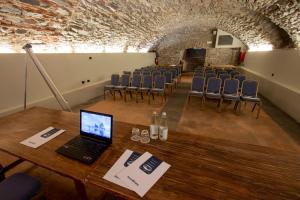 a room with a table and chairs and a laptop at Albergo Le Due Corti in Como