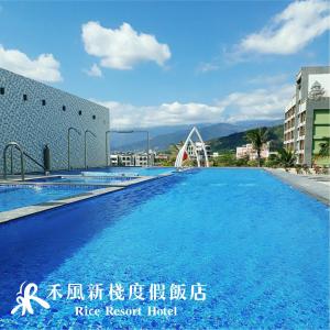 a large swimming pool in front of a building at Rice Resort Hotel in Taitung City