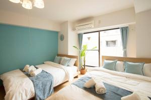 東京にあるRoppongi Azabu Gorgeous Sea Houseのベッド2台と窓のある寝室
