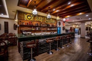 a bar in a restaurant with bar stools at Chunlee Grand Korat in Nakhon Ratchasima