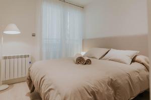 מיטה או מיטות בחדר ב-Apartamento de Esther y Javi