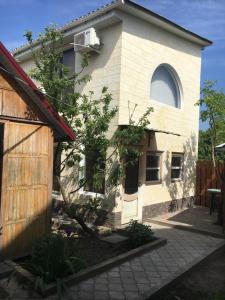 a white house with a window on the side of it at Будиночок для відпочинку in Odesa