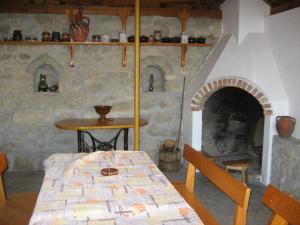 uma sala de jantar com uma mesa e uma lareira de pedra em Guest House Astra em Arbanasi