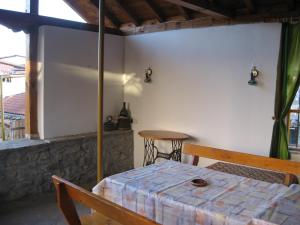 a table and a chair in a room with a table at Guest House Astra in Arbanasi