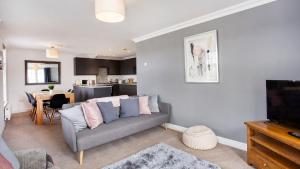 a living room with a couch and a television at Fountains view Apartment in York