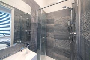 a bathroom with a glass shower and a sink at Blackbird Luxury Apartments Room 3 in Blackpool +10 photos