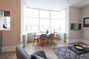 a living room with a table and chairs at Blackbird Luxury Apartments Room 3 in Blackpool