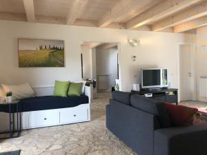 a living room with a couch and a tv at Luxurious Holiday Home in Bagni di Lucca with Pool in Bagni di Lucca