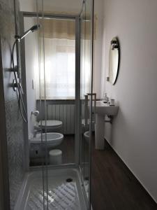 a bathroom with a shower and a toilet and a sink at Casa Grazia in Crispiano