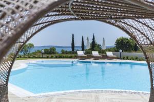 a large swimming pool with lounge chairs and avationliest at Azur Apartment Deluxe in Chernomorets
