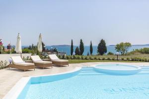 a swimming pool with two lounge chairs and a swimming pool at Azur Apartment Deluxe in Chernomorets