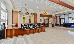 a lobby with a reception desk and clocks at Hotel Snowcrests Manor in Manāli