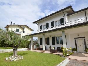 a large white house with a yard at Spacious Villa with Garden in Gemmano in Gemmano