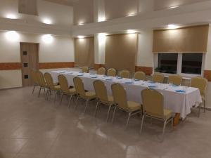 a conference room with a long table and chairs at Viešbutis Kelyje in Utena