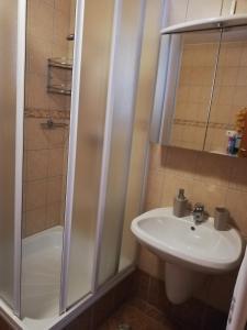 a bathroom with a sink and a shower at Bokréta Üdülő in Mezőkövesd