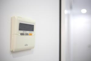 a white machine on a wall next to a door at Apartamento Centro San Diego in Sanlúcar de Barrameda