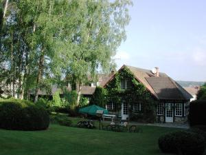 a house with a picnic table in front of it at La Croix du Reh in Châteauneuf-la-Forêt