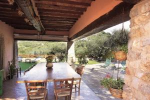 a wooden table and chairs on a patio at La Corte del Falco in Pieve a Nievole