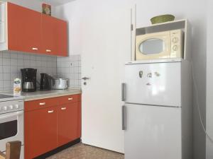 a kitchen with a white refrigerator and a microwave at Gertrud in Gaschwitz