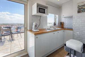 a kitchen with a view of a balcony at knokkeappart Penthouse 2-3 pers in Knokke-Heist