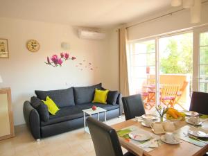 a living room with a blue couch and a table at Apartments Villa Rea in Orebić