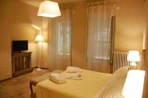 Posteľ alebo postele v izbe v ubytovaní Le Serre Suites & Apartments