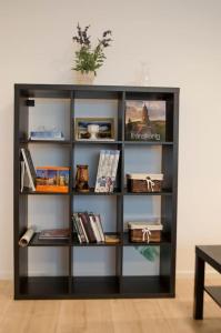 a book shelf against a wall with books at Paul's place. New rooftop apartment in Downtown Sibiu in Sibiu