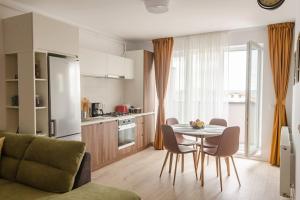 a kitchen and dining room with a table and chairs at Paul's place. New rooftop apartment in Downtown Sibiu in Sibiu