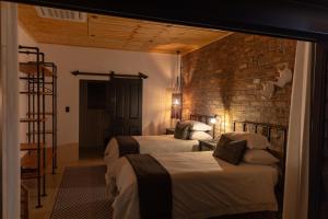 En eller flere senger på et rom på Kransplaas - Nyala Lodge