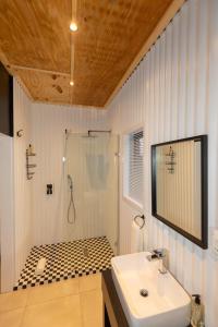 a white bathroom with a sink and a shower at Kransplaas - Nyala Lodge in Graaff-Reinet