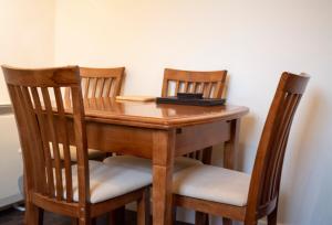 a table with two chairs and a wooden table with at Apartment 2, Pheonix Flats in Portree