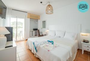 Postel nebo postele na pokoji v ubytování Hostal del Cabo